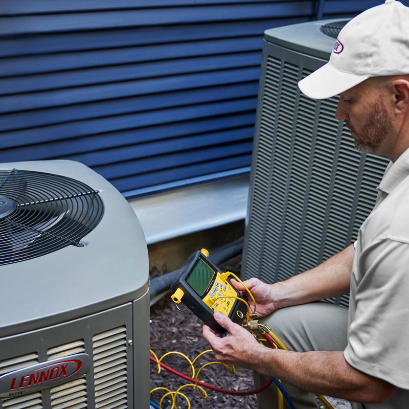 man repairing ac unit