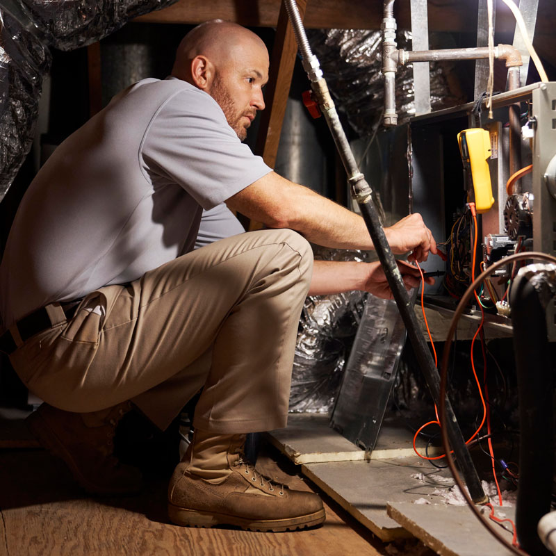 man repairing furnace